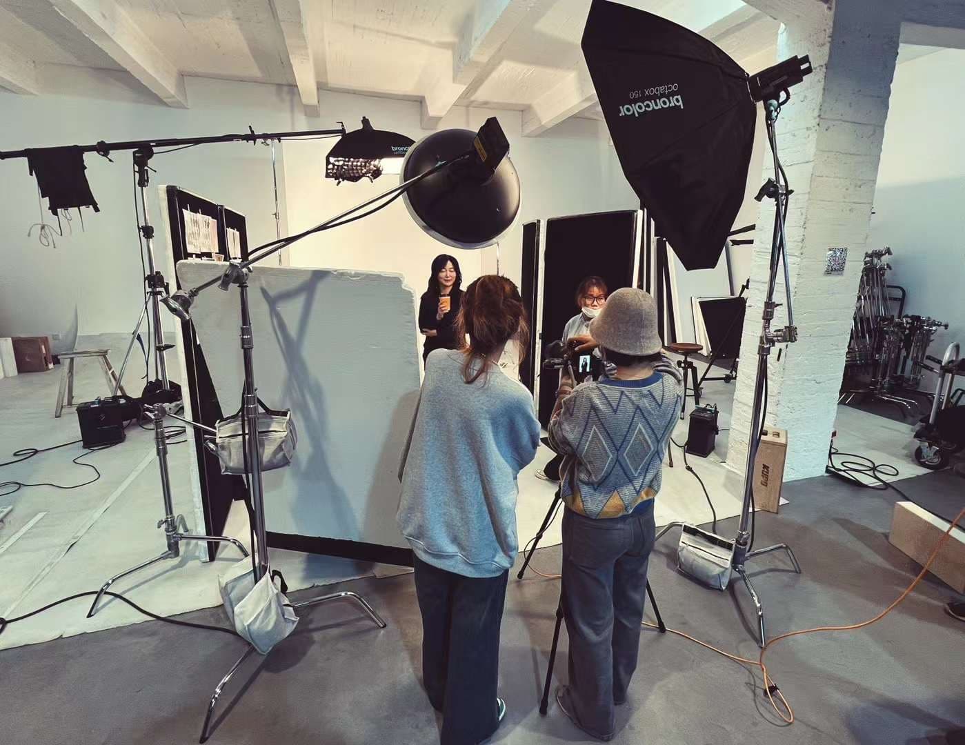 Behind the scenes of portrait session with model and crew using Broncolor studio lighting by Una Zhu