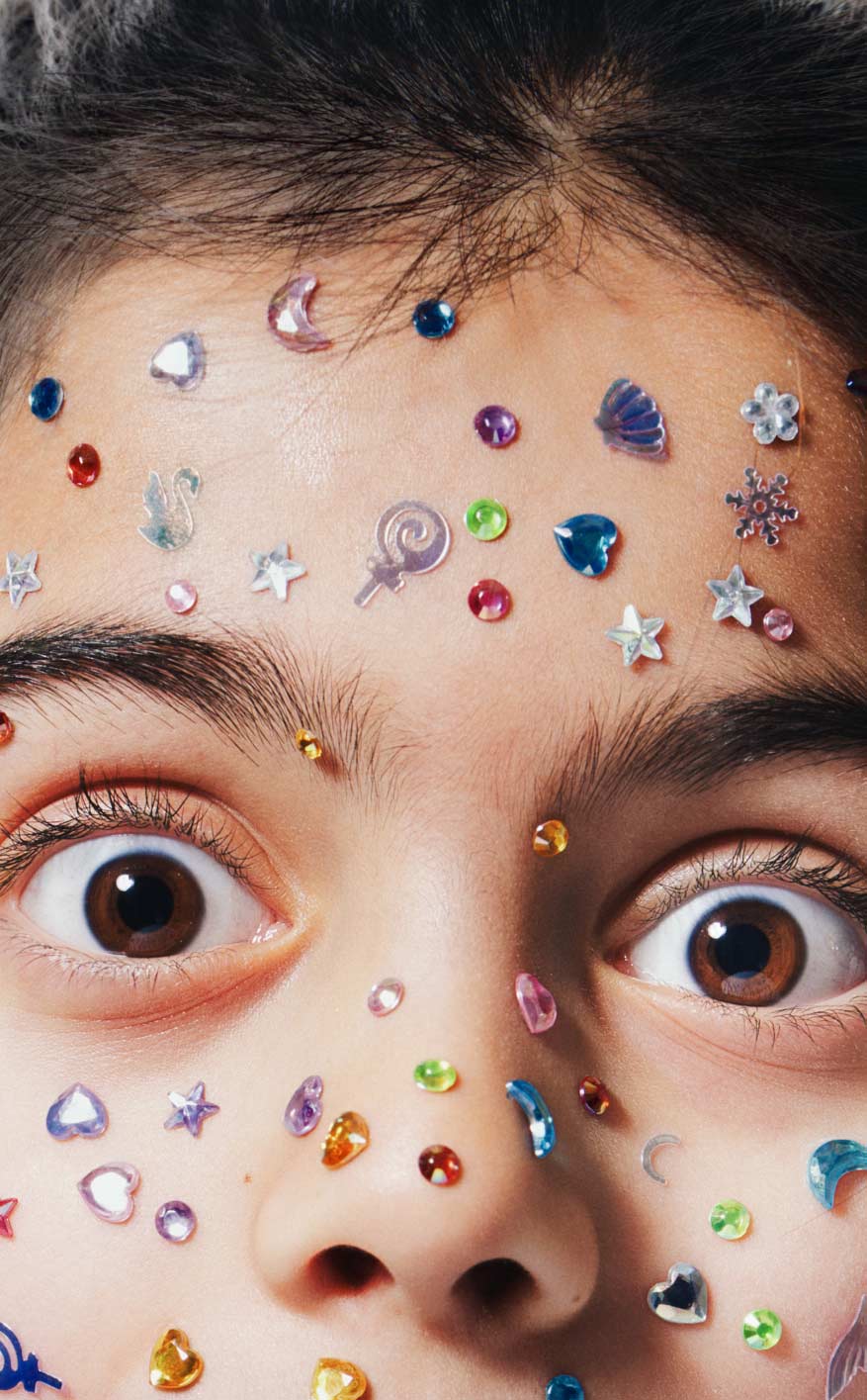 Editorial kids commercial portrait with colorful face gem accessories in Vancouver by Una Zhu