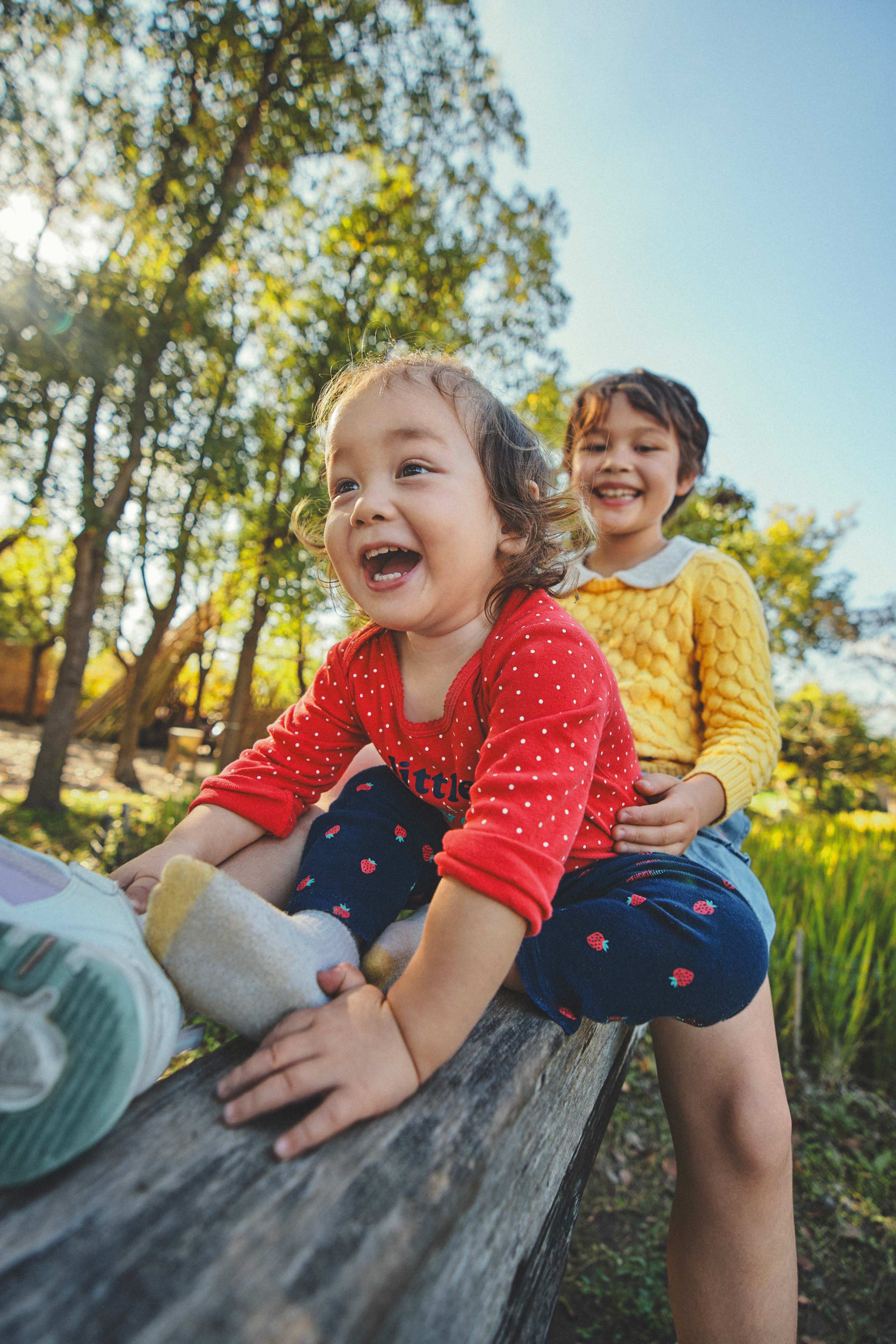 Lifestyle children clothing campaign with toddler laughing in natural light by Una Zhu