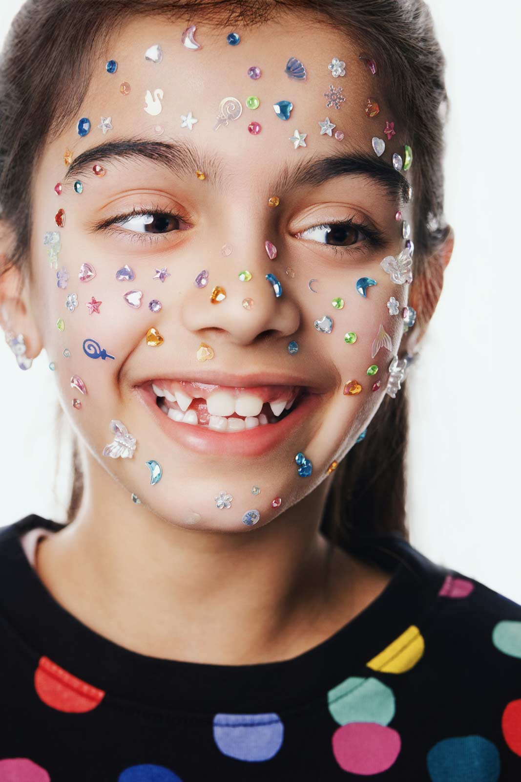 Natural light kids headshot with face gem accessories for talent portfolio in Vancouver by Una Zhu